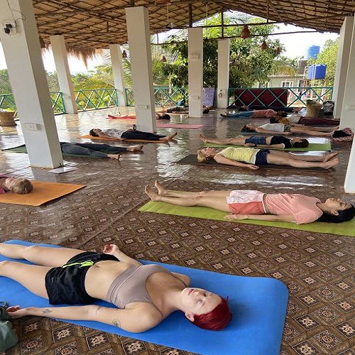People are attending Yoga classes at India Yoga School A group of people doing Yoga at India Yoga School.