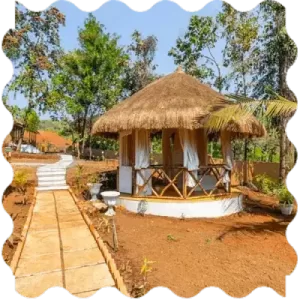 A straw hut at India Yoga School A straw hut with a walkway in the middle of it at India Yoga School.