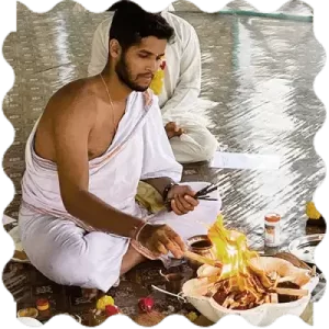 A person doing fire ritual A person doing fire ritual at India Yoga School